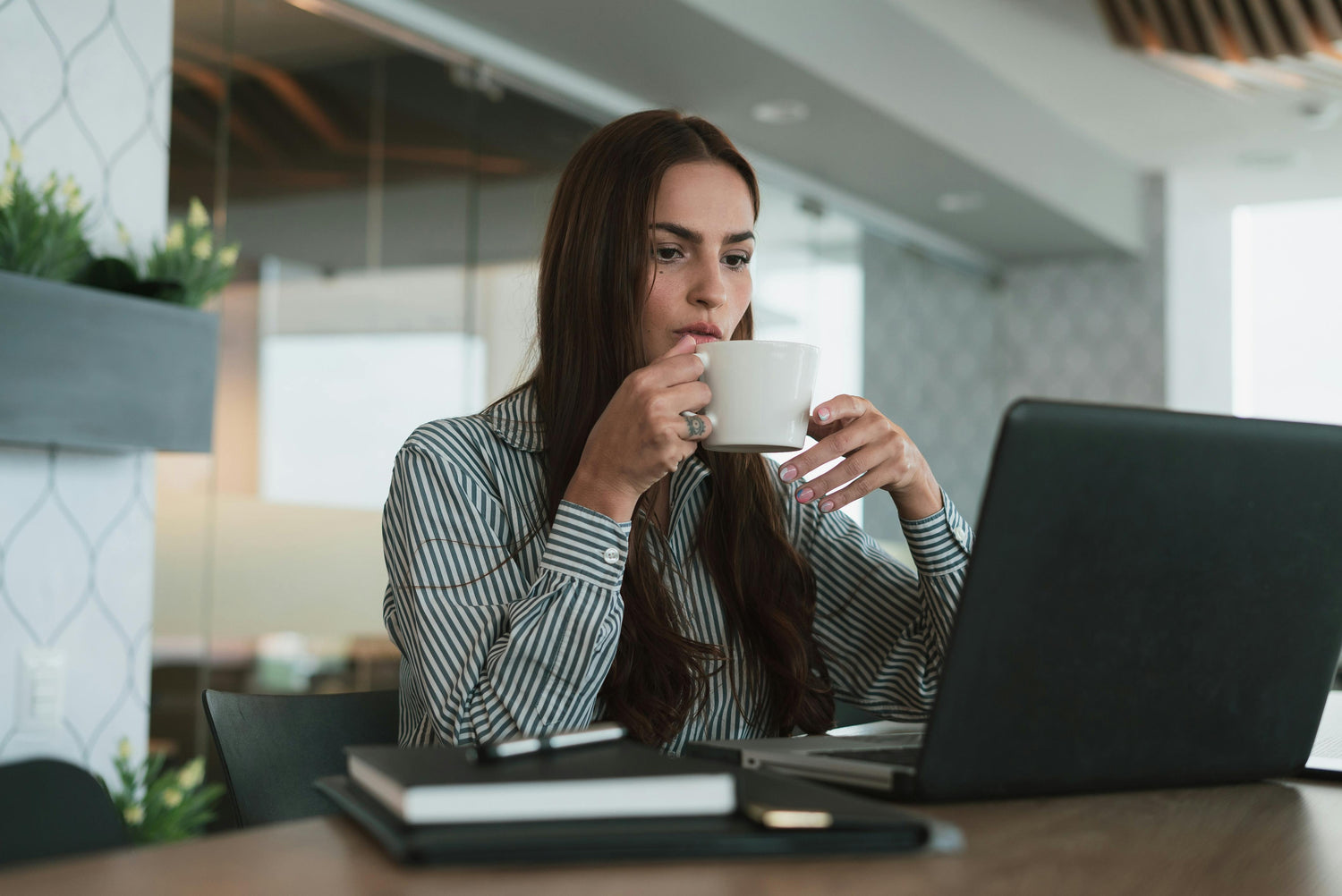 Professional woman at work feeling at ease and styled in her clothes.