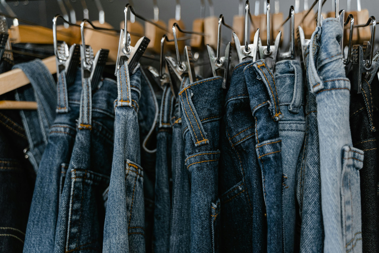 Rack full of denim jeans in multiple washes curated by Styled After.
