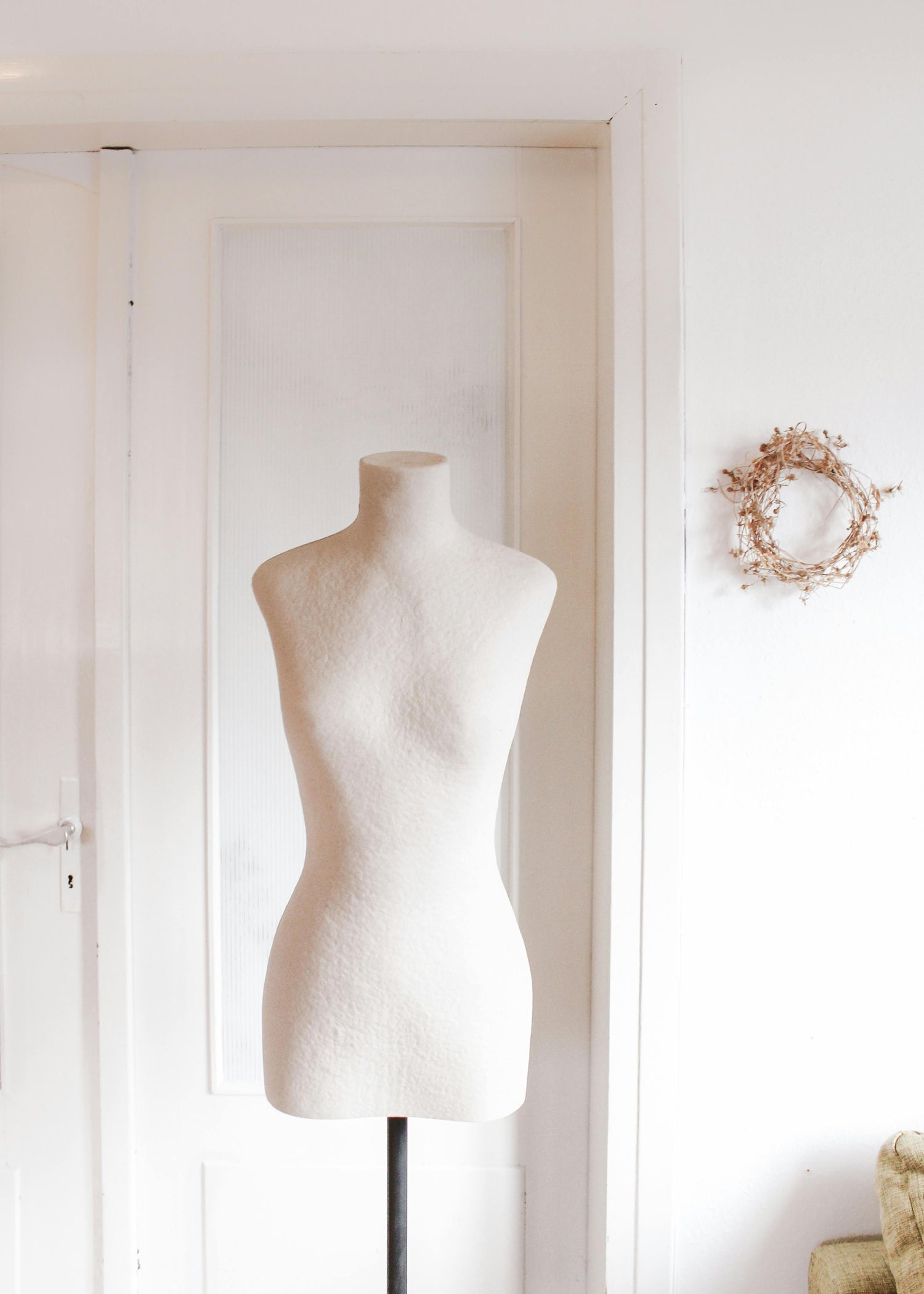 All white room with a white dress form curated by Styled After.