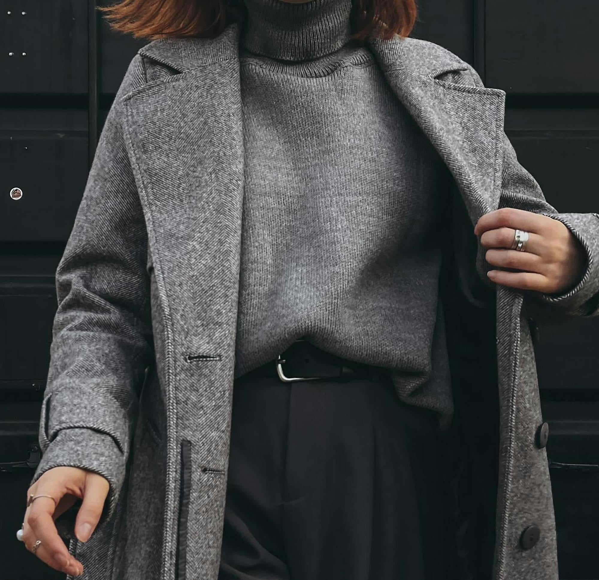 A professional, accomplished woman dressed in a gray monochrome look headed into the office.