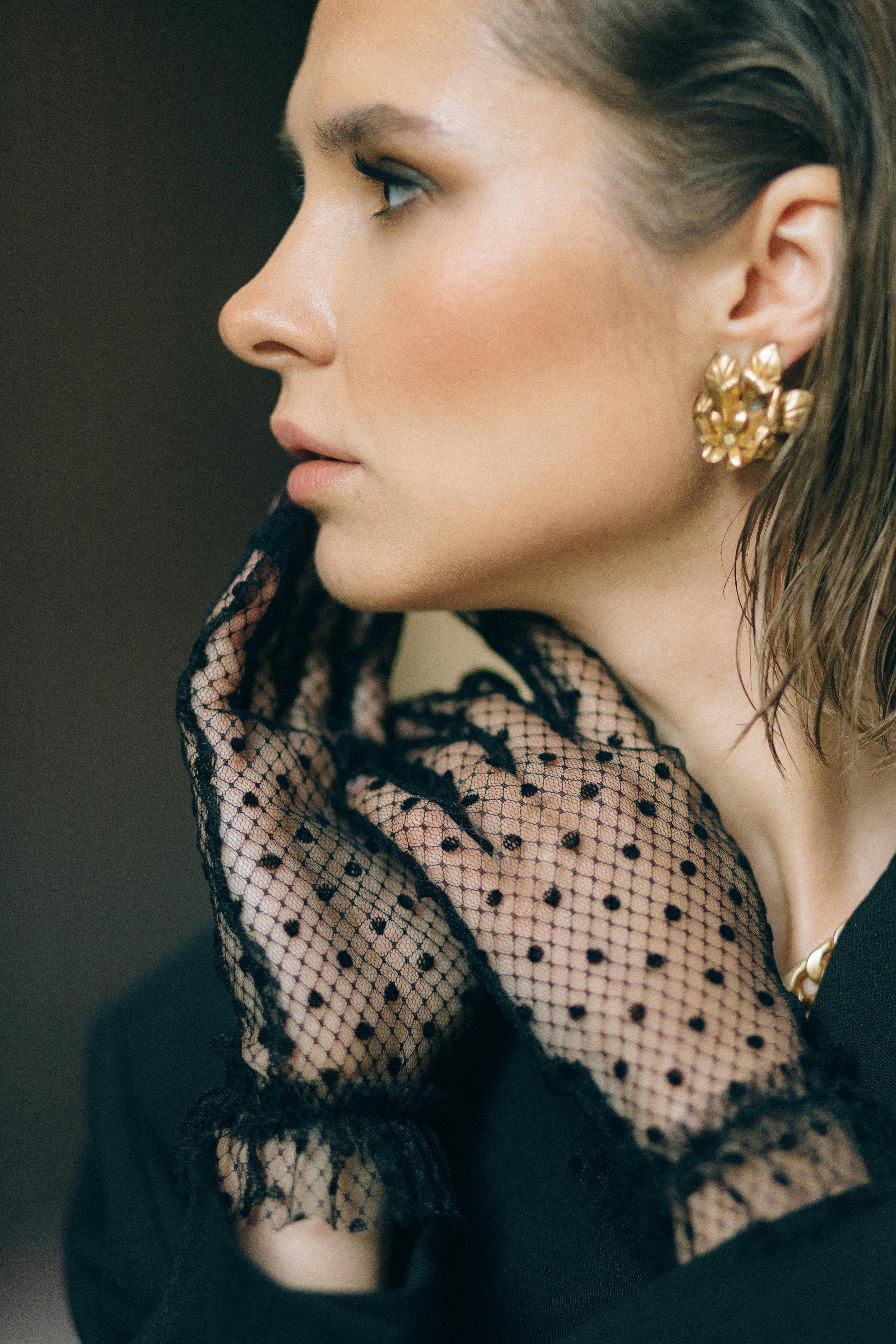 Lace polka-dot gloves with large gold earrings, elegant style curated by Styled After. 